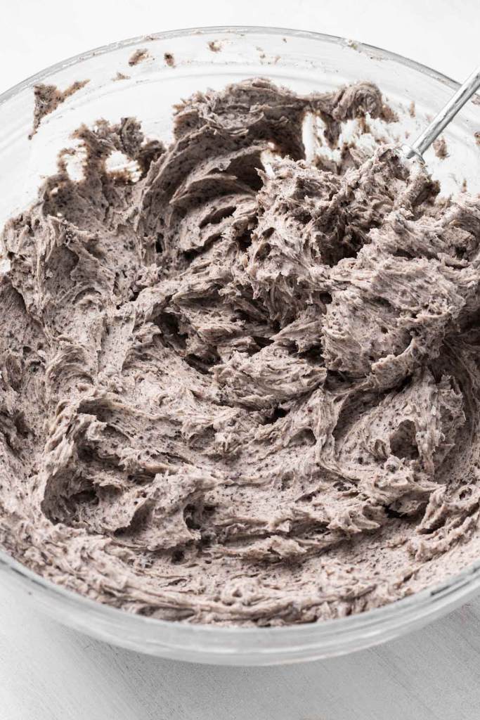 Oreo buttercream frosting in a glass mixing bowl. 