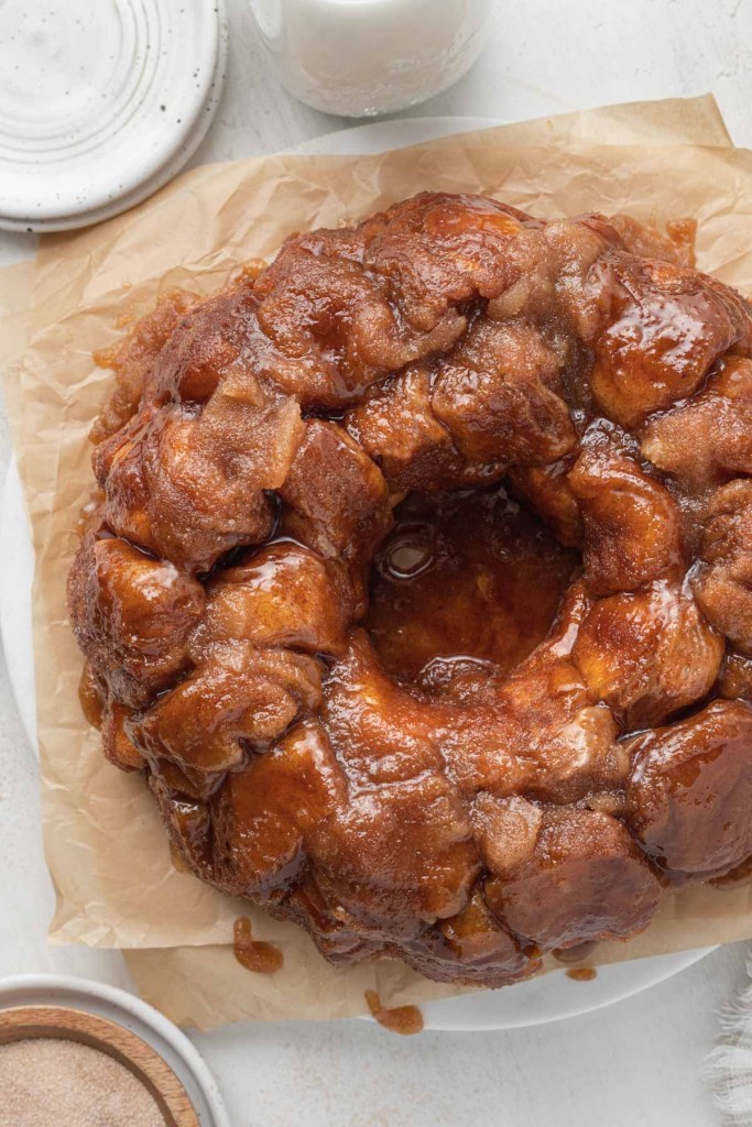 An overhead view of pull apart monkey bread on parchment paper. 