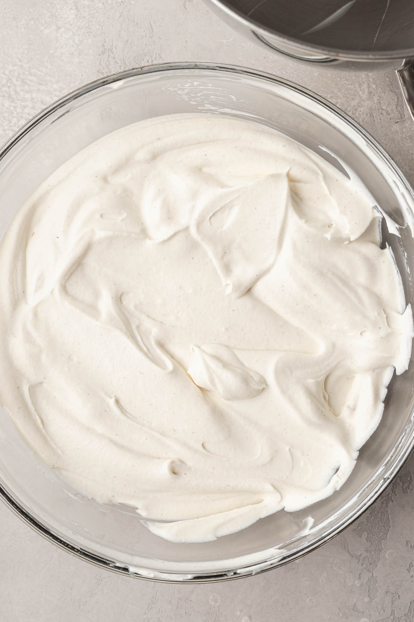 Vanilla ice cream mixed together in a glass mixing bowl.